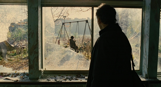 Wide shot frame from Children of Men — sitting, standing, dog