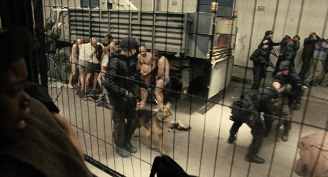 Wide shot frame from Children of Men — standing, dog, person