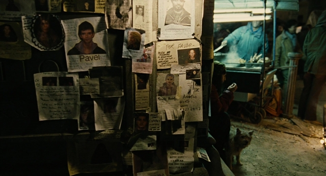 Wide shot frame from Children of Men — walking, dog, person