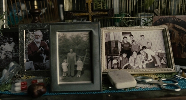 Wide shot frame from Children of Men — table, dog, suit