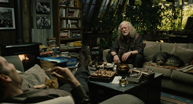 Wide shot frame from Children of Men — sitting, room, table