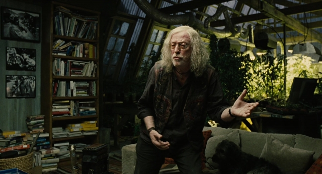 Wide shot frame from Children of Men — book, standing, room