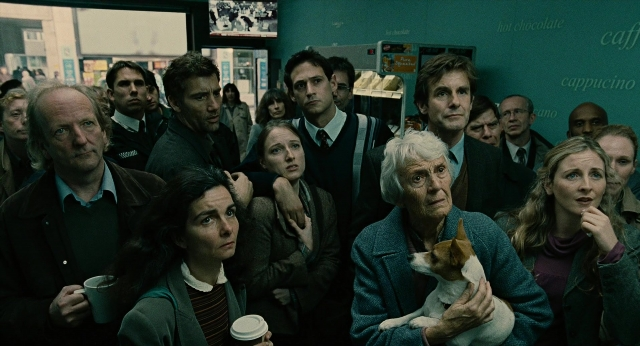 Wide shot frame from Children of Men — standing, room, dog