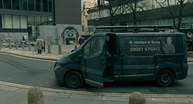 Wide shot frame from Children of Men — walking, street, van