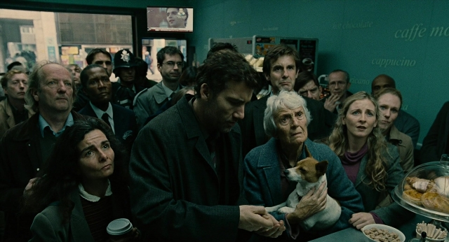 Wide shot frame from Children of Men — table, phone, dog