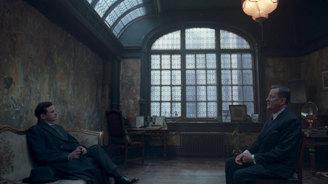Wide shot frame from The King's Speech — sitting, standing, room