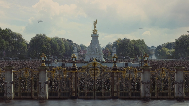 Wide shot frame from The King's Speech — water, tower, person