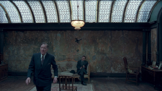 Medium shot frame from The King's Speech — sitting, walking, room