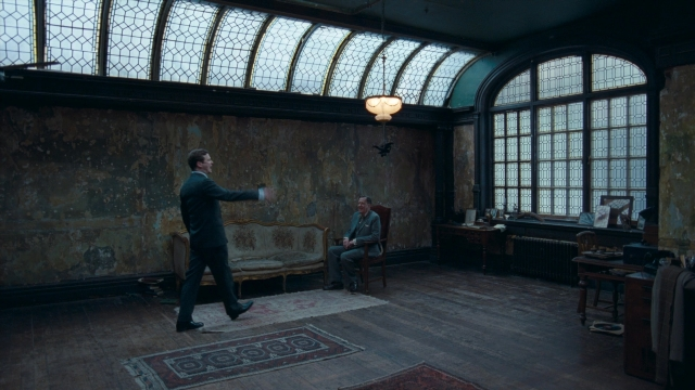 Wide shot frame from The King's Speech — sitting, standing, room