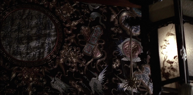 Wide shot frame from The Last Emperor — bird, window