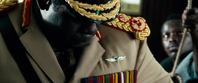 Wide shot frame from The Last King of Scotland — uniform, coat, bird
