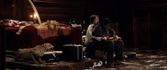 Wide shot frame from The Last King of Scotland — sitting, bed, lamp