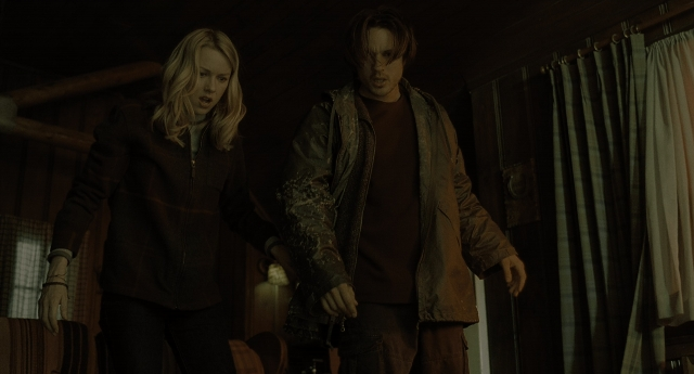 Wide shot frame from The Ring — standing, room, jacket