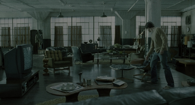 Wide shot frame from The Ring — walking, room, table