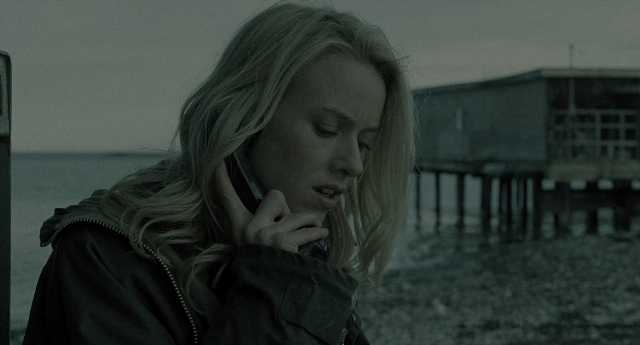 Wide shot frame from The Ring — standing, phone, jacket