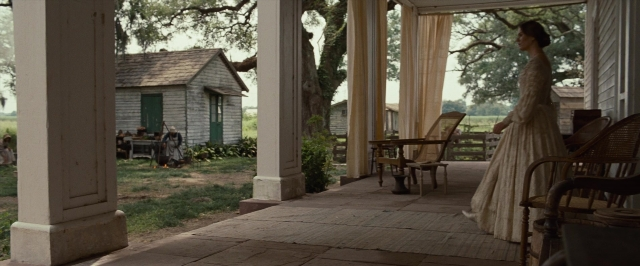 Wide shot frame from 12 Years a Slave — book, standing, table