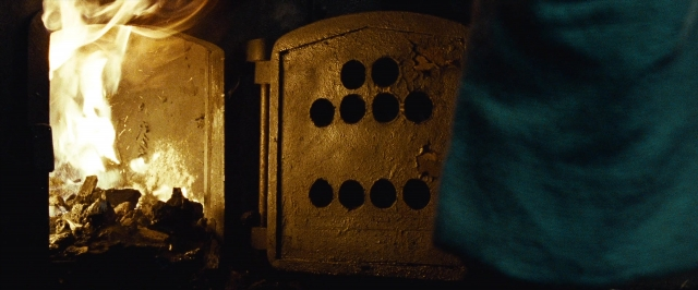 Wide shot frame from 12 Years a Slave — fire, fireplace