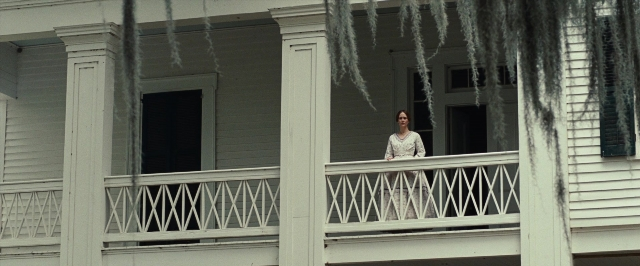 Wide shot frame from 12 Years a Slave — standing, house, dress