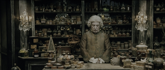 Wide shot frame from Perfume: The Story of a Murderer — sitting, table, coat