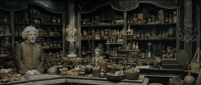 Wide shot frame from Perfume: The Story of a Murderer — sitting, suit, tie
