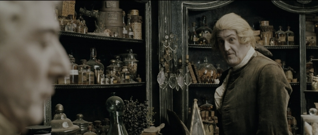 Wide shot frame from Perfume: The Story of a Murderer — standing, mirror, coat