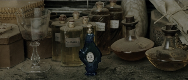 Wide shot frame from Perfume: The Story of a Murderer — room, table, bottle