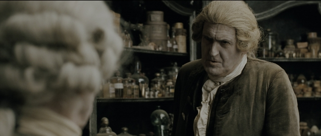 Wide shot frame from Perfume: The Story of a Murderer — standing, coat, shirt