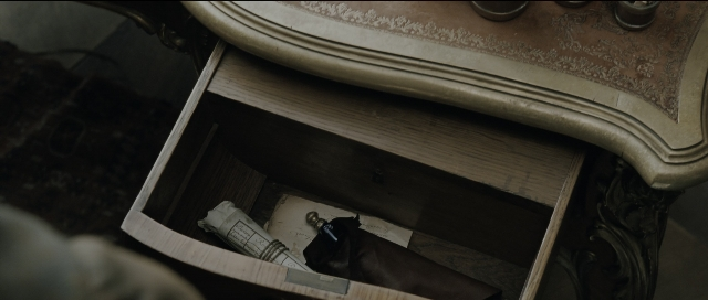 Wide shot frame from Perfume: The Story of a Murderer — bottle, chair, furniture