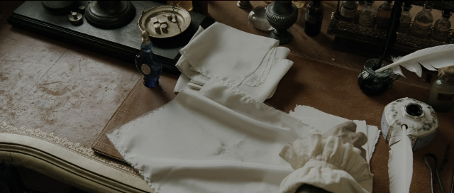 Wide shot frame from Perfume: The Story of a Murderer — table, bottle, lamp