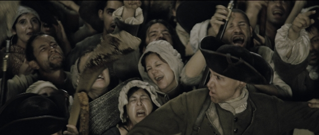 Wide shot frame from Perfume: The Story of a Murderer — hat, coat, hand