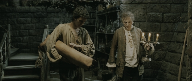Wide shot frame from Perfume: The Story of a Murderer — room, coat, person