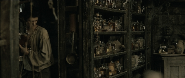 Wide shot frame from Perfume: The Story of a Murderer — standing, room, hand