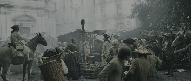 Wide shot frame from Perfume: The Story of a Murderer — standing, street, hat