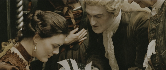 Wide shot frame from Perfume: The Story of a Murderer — standing, suit, dress