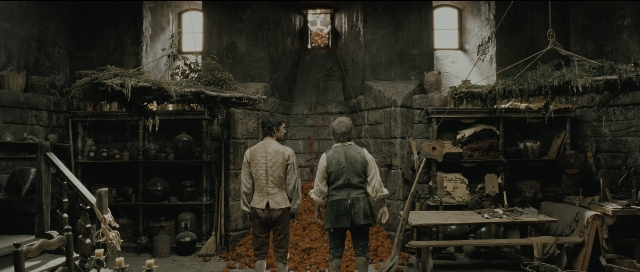 Wide shot frame from Perfume: The Story of a Murderer — standing, room, table