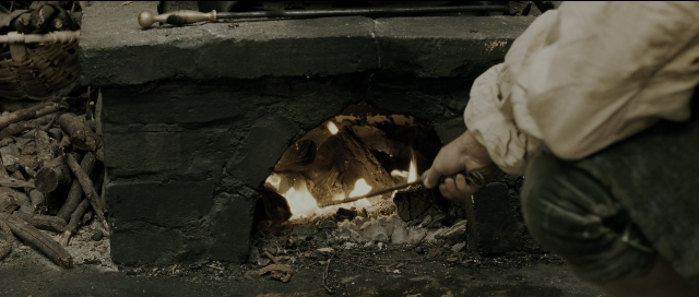 Wide shot frame from Perfume: The Story of a Murderer — fire, person