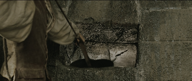 Wide shot frame from Perfume: The Story of a Murderer — hand, shirt, face