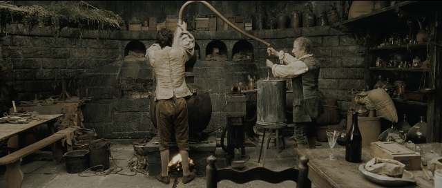 Medium shot frame from Perfume: The Story of a Murderer — standing, room, table