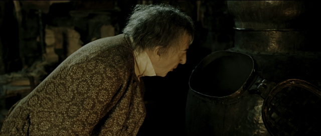 Wide shot frame from Perfume: The Story of a Murderer — standing, room, coat