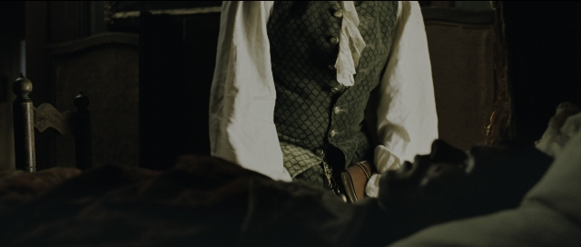 Wide shot frame from Perfume: The Story of a Murderer — room, bed, shirt