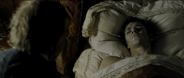 Wide shot frame from Perfume: The Story of a Murderer — standing, bed, face
