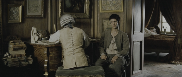 Wide shot frame from Perfume: The Story of a Murderer — sitting, book, room