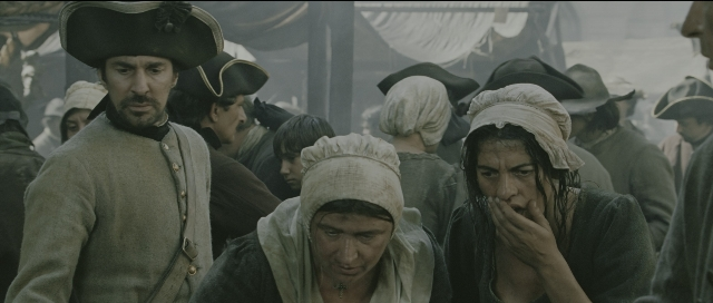 Wide shot frame from Perfume: The Story of a Murderer — standing, hat, coat