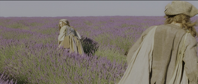 Wide shot frame from Perfume: The Story of a Murderer — walking, dress, lavender