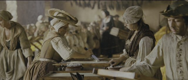 Wide shot frame from Perfume: The Story of a Murderer — standing, table, hat