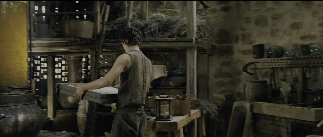 Wide shot frame from Perfume: The Story of a Murderer — standing, table, shirt
