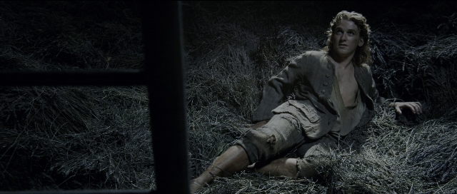 Wide shot frame from Perfume: The Story of a Murderer — sitting, bed, face