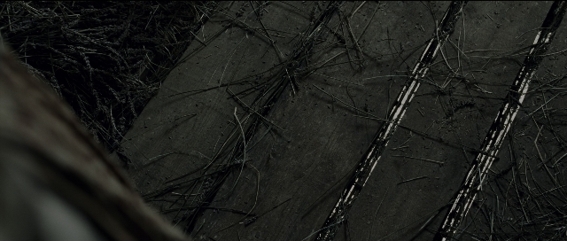 Wide shot frame from Perfume: The Story of a Murderer — forest, car tire