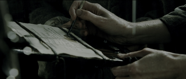 Wide shot frame from Perfume: The Story of a Murderer — sitting, person, human hand