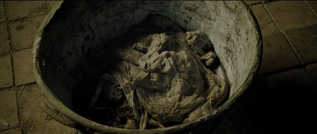 Wide shot frame from Perfume: The Story of a Murderer — waste container